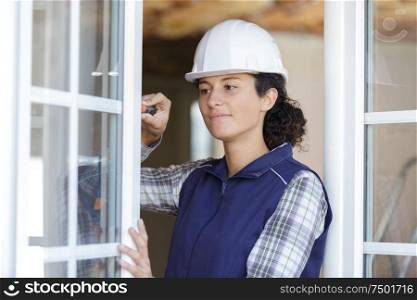 a female worker is fixing the window