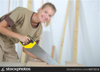 a female worker using handsaw