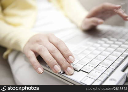 A Female works on a PC