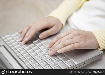 A Female works on a PC