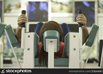 A female works out in a gym. Picture has shallow depth of field