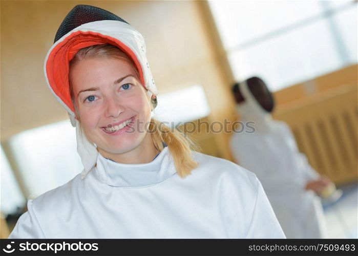 a fencer posing and smiling