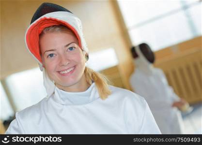 a fencer posing and smiling