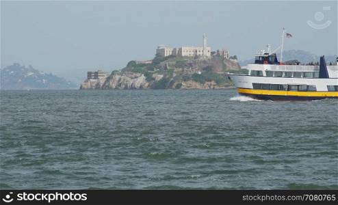 A ferry floats by Alcatraz
