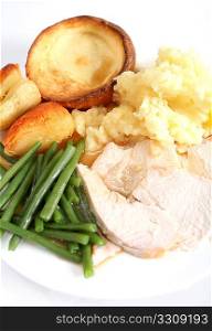 A festive dinner with turkey breast, green beans, roast and mashed potatoes and yorkshire pudding