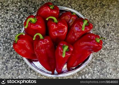 A few red, ripe, raw peppers, paprika or Capsicum with green stem prepared for canning, Sofia, Bulgaria