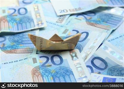 A Fifty euro banknote boat on a twenty euro notes sea