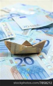 A Fifty euro banknote boat on a twenty euro notes sea