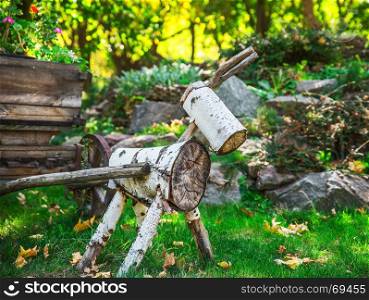a figure of wood logs in the garden on a summer day