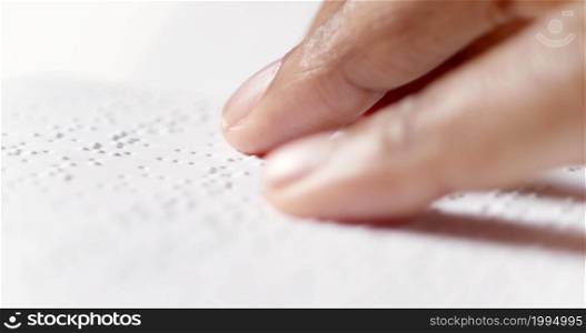 A finger is reading braille