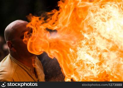 A Fire show artist breathe fire in the dark jamp