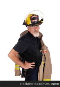 A firefighter man with his jacket over his shoulder and helmet on hishead, looking into the camera, standing isolated for white background