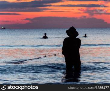 A fisherman is fishing at Sunset on Koh Rong. A fisherman is fishing at Sunset on Koh Rong, Cambodia