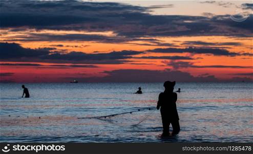 A fisherman is fishing at Sunset on Koh Rong. A fisherman is fishing at Sunset on Koh Rong, Cambodia