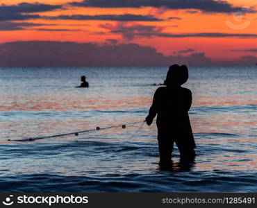 A fisherman is fishing at Sunset on Koh Rong. A fisherman is fishing at Sunset on Koh Rong, Cambodia