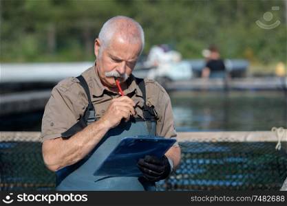 a fisherman with clipboard counting
