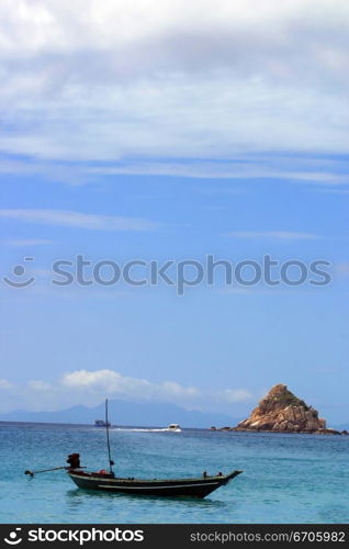 A Fishing boat mores off the coast on Koh Tao, tranquil, tranquility, tropical, paradise, pristine, tropical, heaven, delight, joy, haven, retreat, sanctuary, oasis, Thailand.