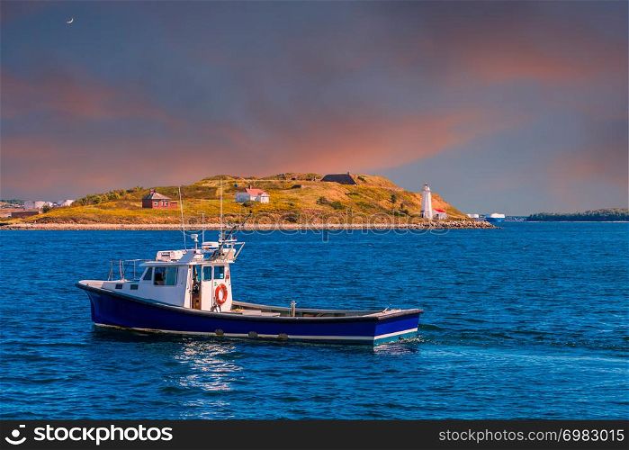 A Fishing Boat Past a Small Lighthouse and Shed in Halifax, Nova Scotia, Canada