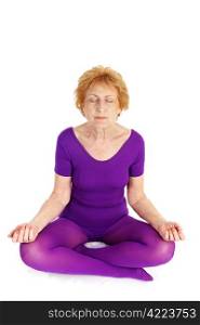 A fit seventy year old woman meditating during a yoga practice. White background.