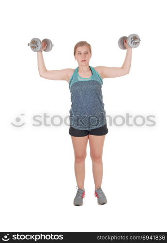 A fit young slim woman standing isolated for white background andlifting two dumbbell?s up to exercise her strength