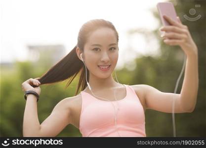 A fitness woman holding her phone