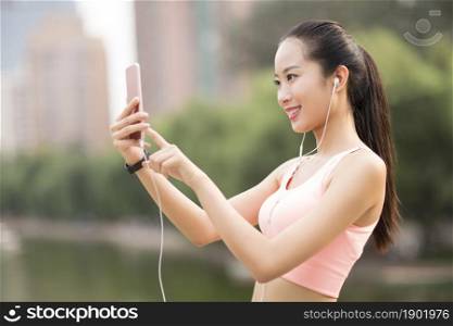 A fitness woman taking selfies with her phone