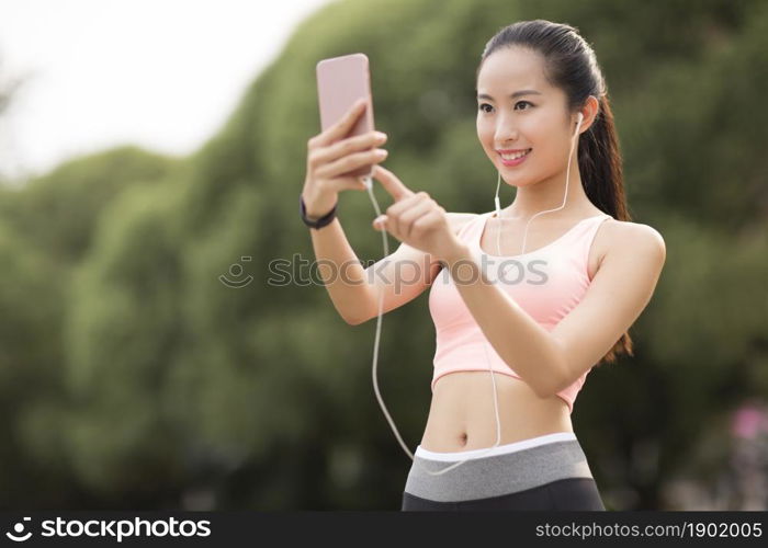 A fitness woman taking selfies with her phone