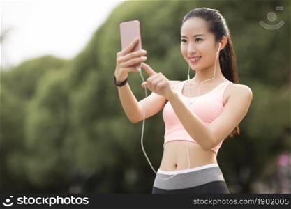 A fitness woman taking selfies with her phone