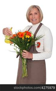 A florist spraying flowers with water