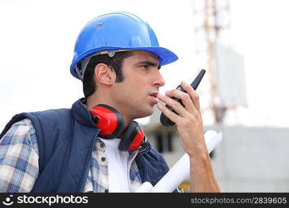 A foreman giving instructions through his cb.