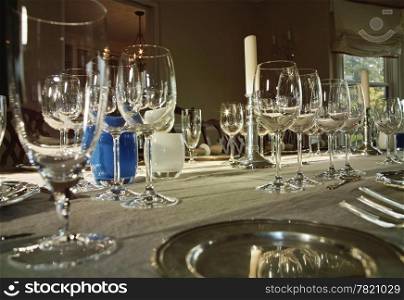 A formal dinner table set with mulitiple wine glasses for a wine tasting party.