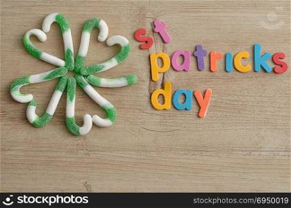 A four leaf clover made out of green and white candy cane with the words saint patricks day