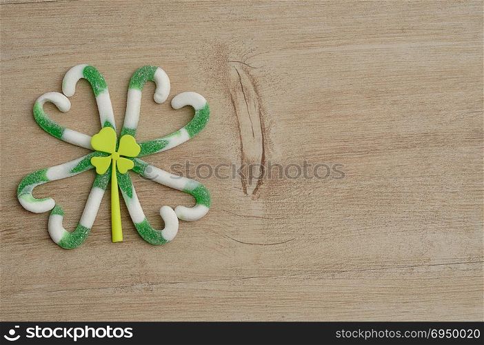 A four leaf clover made out of green and white candy cane