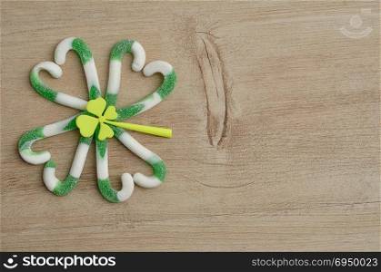 A four leaf clover made out of green and white candy cane