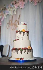 A four-story wedding cake.. A huge cake decorated with fruits and berries for the wedding 2775.