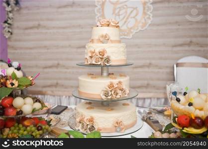 A four-story wedding cake.. A huge cake decorated with fruits and berries for the wedding 2787.