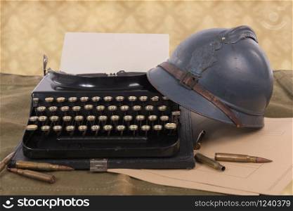 a french military helmet of the First World War with old typewriter
