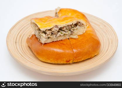 a fresh chicken pie on a wooden dish