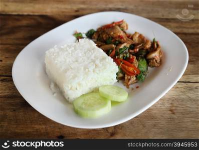 A fresh dish of Thai style food, Fried pork with sweet basil and white jasmine sticky rice