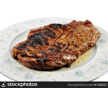 a fresh grilled steak on a plate ,close up
