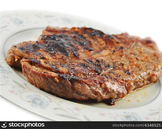 a fresh grilled steak on a plate ,close up