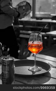 a fresh orange cocktail for a break in a ski hut is on the table in a glass. a fresh cocktail drink for a break at a ski hut