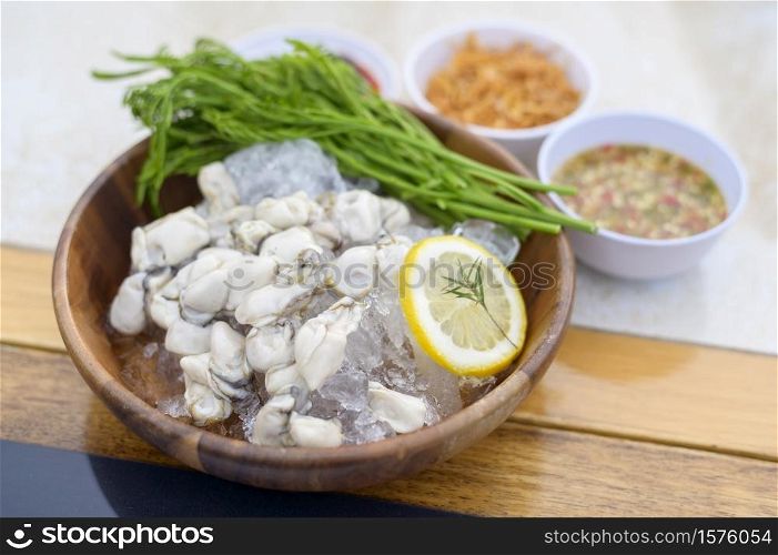 A fresh oysters served in a plate with thai spicy seafood sauce. Fresh oysters served in a plate with thai spicy seafood sauce