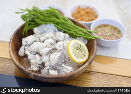 A fresh oysters served in a plate with thai spicy seafood sauce. Fresh oysters served in a plate with thai spicy seafood sauce