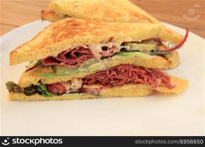 A fresh pastrami sandwich: charcuterie, lettuce, pickles and mayonaisse. Fresh pastrami sandwich
