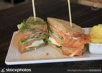 A fresh salmon sandwich: smoked salmon, lettuce, fresh dill and egg. Fresh salmon sandwich