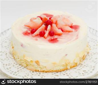 a fresh sponge soufflA cake, strawberries and redcurrants on top