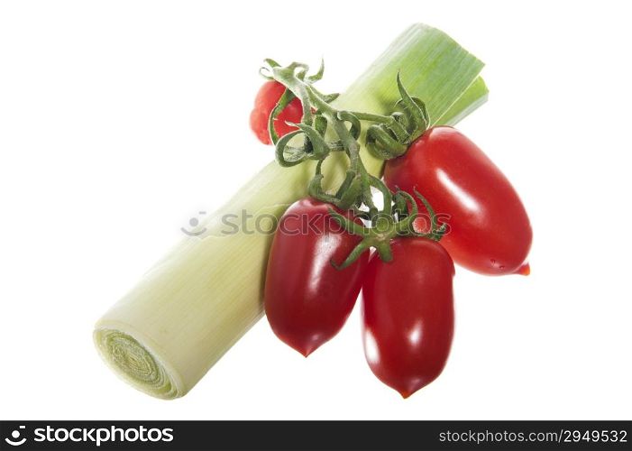 a freshness leeks and tomatoes on the white background