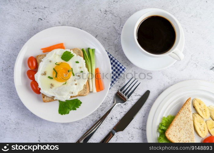 A fried egg laying on a toast, topped with pepper seeds with carrots and spring onions.