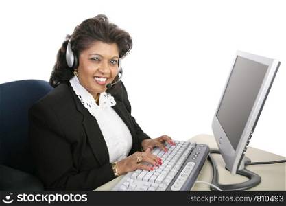 A friendly Indian woman at the computer offering technical support. Isolated on white.